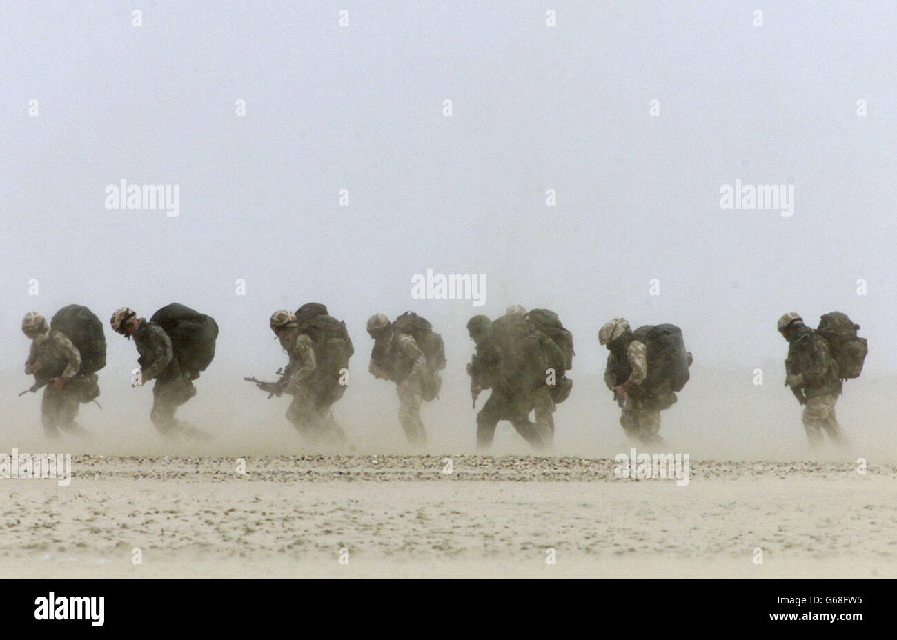 I soldati britannici del 51° reggimento della Royal Air Force Sqn si dirigono attraverso una nuvola di sabbia mentre si preparano a salire a bordo di un elicottero Chinook durante un'operazione di attacco aereo progettata per catturare un campo aereo nemico, fuori Kuwait City. Foto Stock