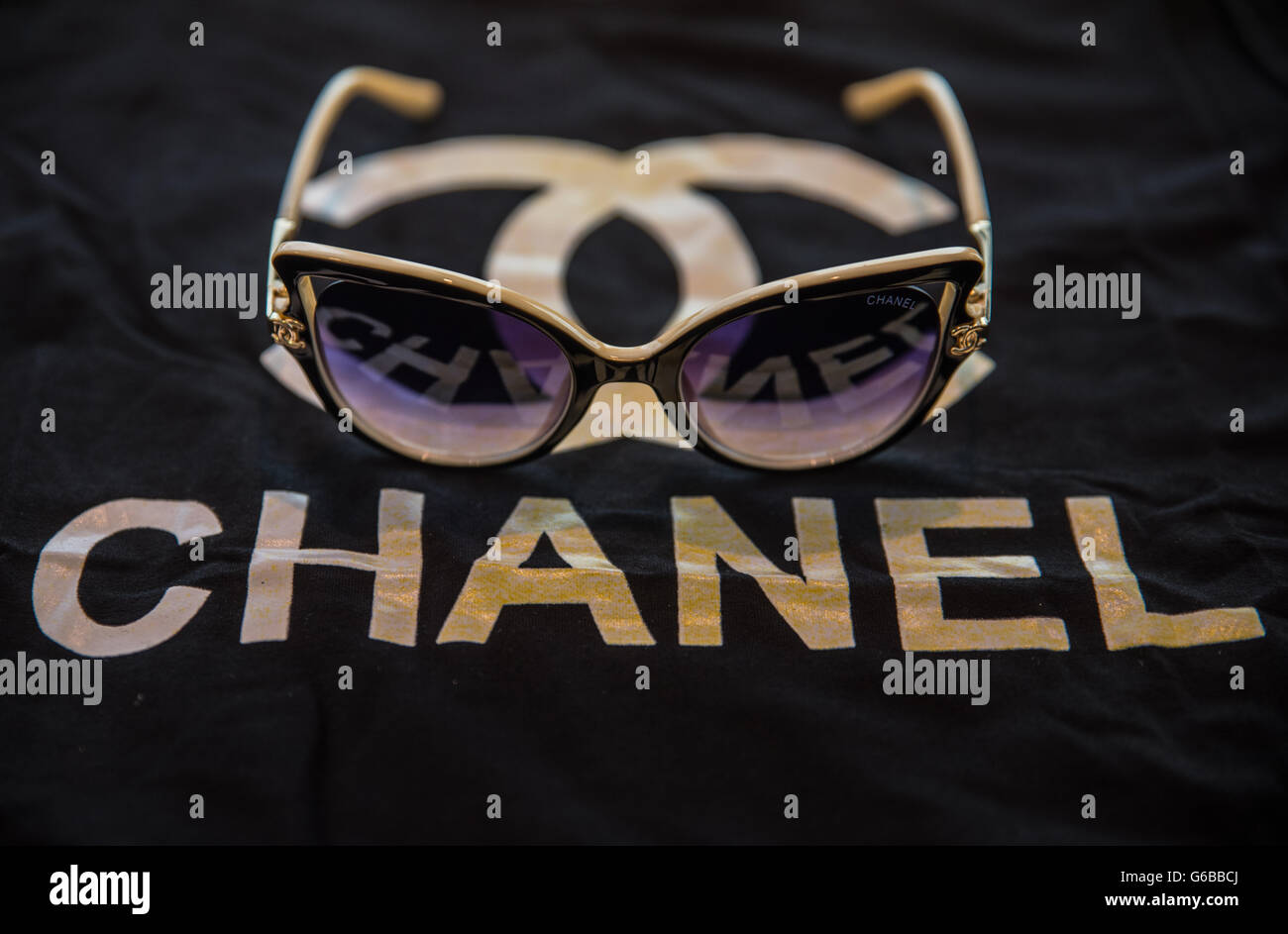 Una coppia di merci contraffatte Chanel occhiali da sole visto sulla parte  superiore di un knockoff t-shirt della stessa marca durante una conferenza  stampa a Frankfurt am Main, Germania, 24 giugno 2016.
