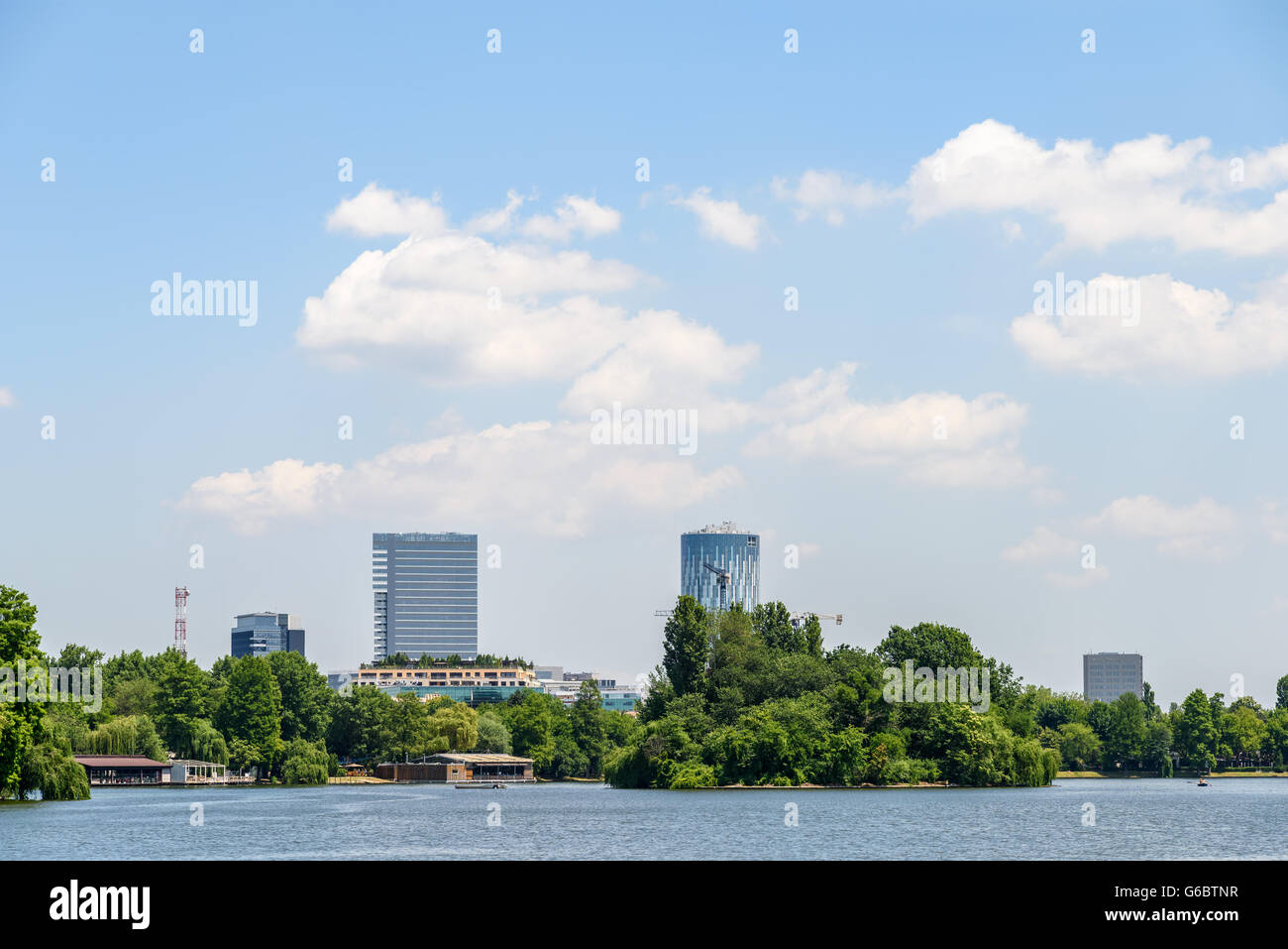 Lo Skyline di Bucarest vista In Herastrau Parco Lago Foto Stock