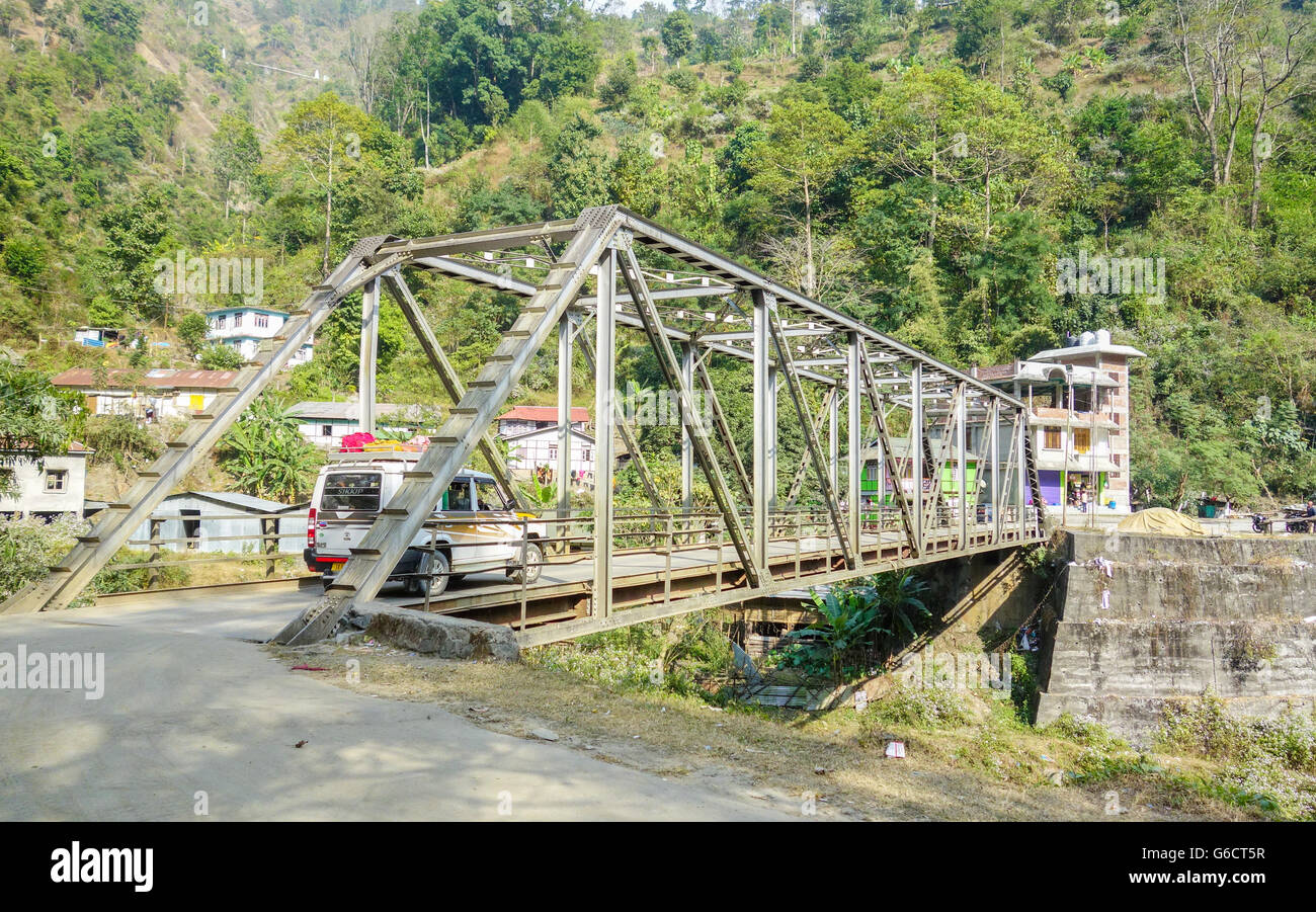Un Tata Sumo veicolo turistico passa sopra un ponte metallico in Sikkim, India Foto Stock