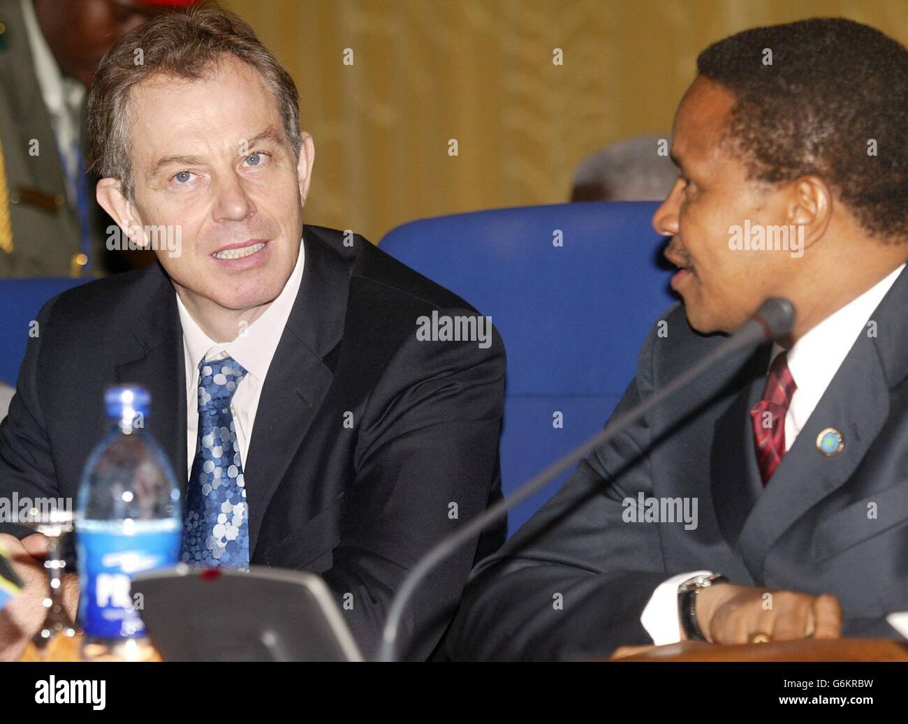 Il primo ministro britannico Tony Blair,(L), parla con il presidente della Tanzania Benjamin William Mkapa all'inizio della prima sessione esecutiva dell'incontro dei capi di governo del Commonwealth ad Abuja, Nigeria. Blair oggi non ha ottenuto la rapida risoluzione che voleva continuare la sospensione dello Zimbabwe dal Commonwealth. Aveva sperato che i leader riuniti in Nigeria accettino di mantenere in vigore le sanzioni contro il regime Zanu-PF di Robert Mugabe nella sessione di apertura del vertice. Foto Stock