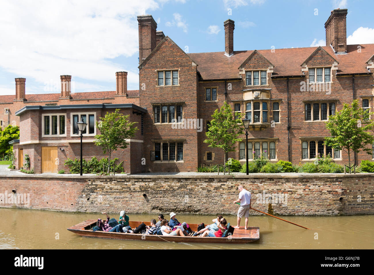 Parte dell'Magdalane edificio College, Università di Cambridge Cambridge Regno Unito con persone passato punting sul fiume Cam Foto Stock