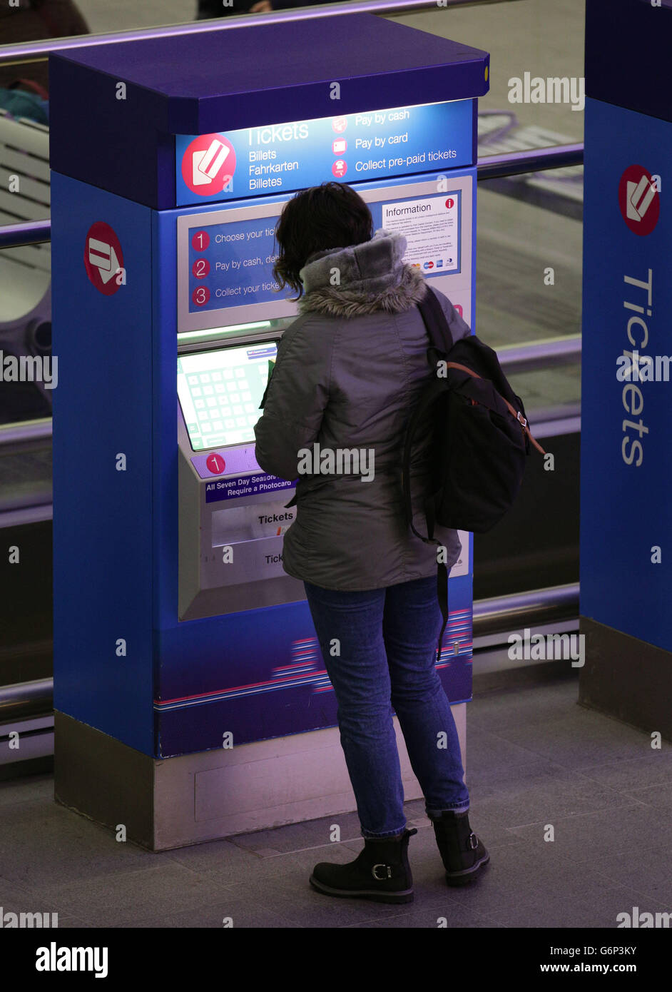 Un pendolarista che utilizza una biglietteria alla stazione di Kings Cross, a Londra, il giorno in cui entrano in vigore le nuove tariffe del treno. Foto Stock