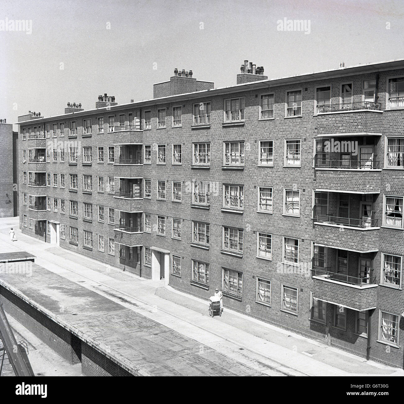 Degli anni Cinquanta, foto storiche che mostra una nuova costruita in mattoni di cinque piani di blocco di appartamenti, Inghilterra. Foto Stock