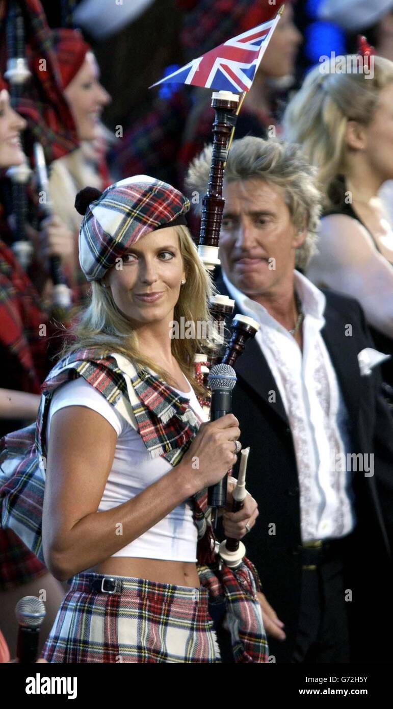 Penny Lancaster, in abito scozzese, si esibisce come ballerina di sostegno per il suo partner Rod Stewart, dal vivo sul palco al concerto Olympic Torch presso il Mall, nel centro di Londra un concerto gratuito organizzato da Visit London e dalla Greater London Authority per celebrare l'arrivo della torcia olimpica a Londra. Foto Stock