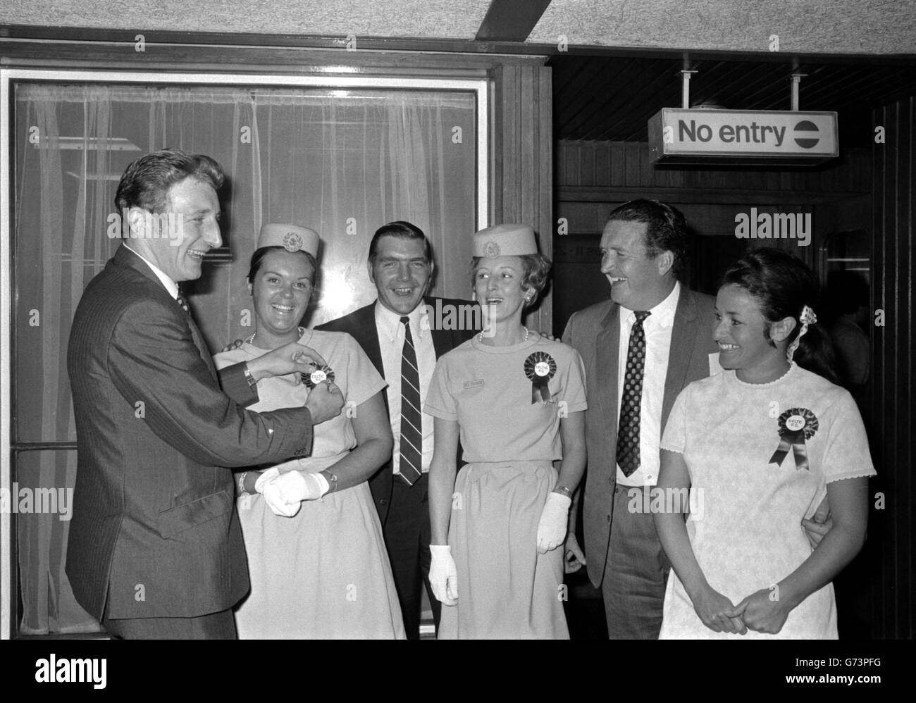 Tre membri del partito Celtic FC reclutano le stewardesses Air France come "sostenitori" - con rosette - all'aeroporto di Heathrow, Londra, prima di volare a Lione, Francia. Da sinistra a destra: Gemmell, Susan Ballantyne, Murdoch, Jill Edison, Jock Stein, direttore celtico e Pat Taylor. I Celtic devono giocare una partita amichevole pre-stagione contro St Etienne. Foto Stock