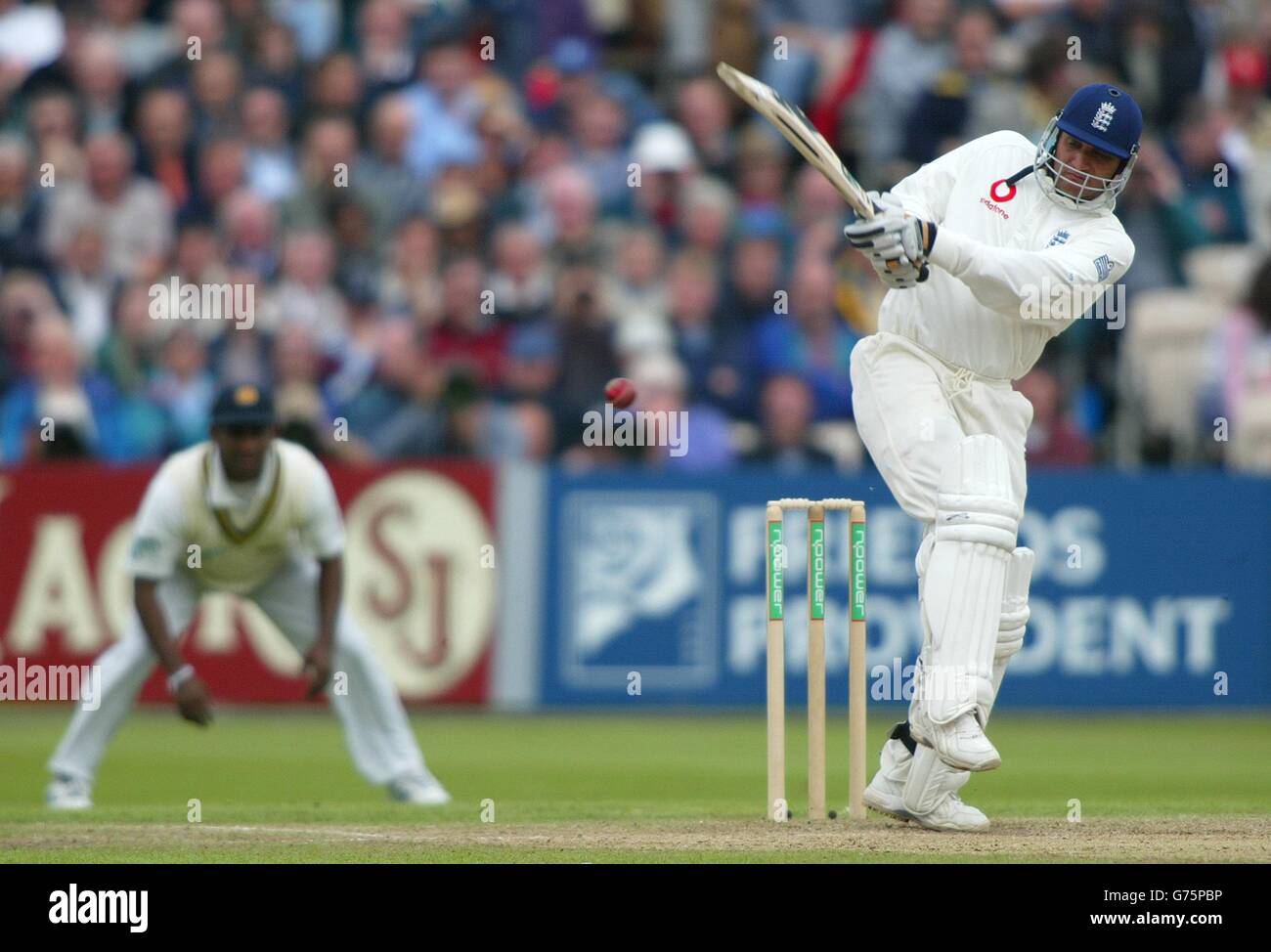 Englands Mark Butcher colpisce un 4 dal bowling di Charminda Vaas dello Sri Lanka durante il 2° giorno del 3° test a Old Trafford, Manchester. Foto Stock