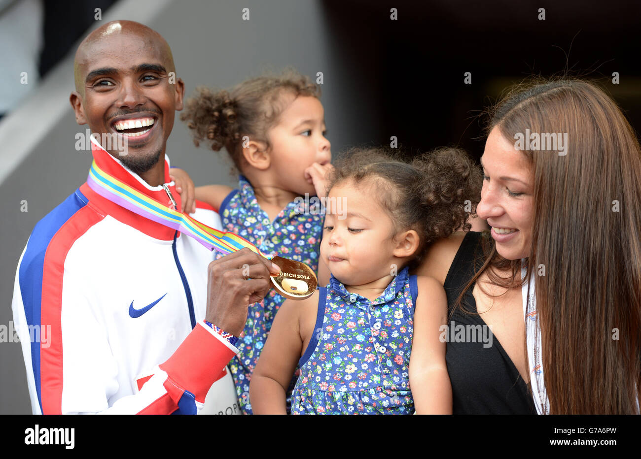 Mo Farah della Gran Bretagna si pone con la moglie Tania e le figlie Aisha e Amani dopo aver vinto la finale maschile di 5000m durante il sesto giorno dei Campionati europei di atletica 2014 allo stadio Letzigrund di Zurigo. Foto Stock