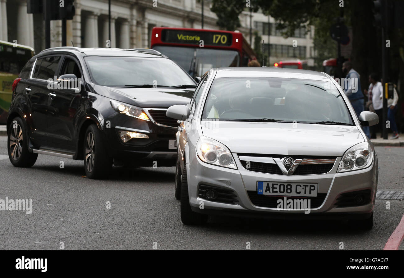 Due auto si susseguono da vicino su Buckingham Palace Road, Westminster, Londra. Foto Stock