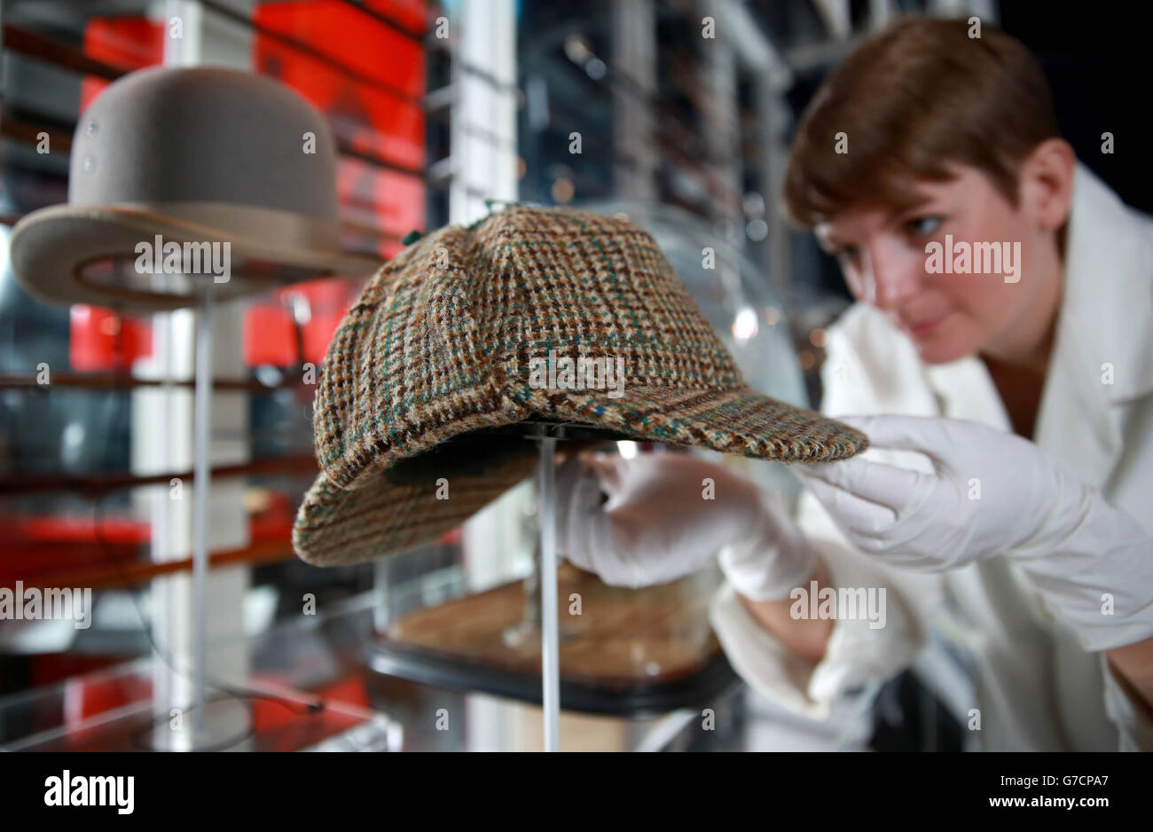 La conservatrice Melina Plottu prepara un cappello a tweed Deerstalker  prima dell'apertura della mostra Sherlock Holmes, che apre al pubblico  venerdì 17 ottobre, presso il Museo di Londra Foto stock - Alamy