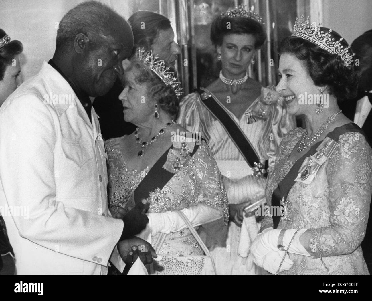 La regina Elisabetta II parla con il presidente dello Zambia Kenneth Kuanda durante un banchetto di Stato al Claridge's di Londra, sullo sfondo la regina madre e la principessa Alexandra. Foto Stock