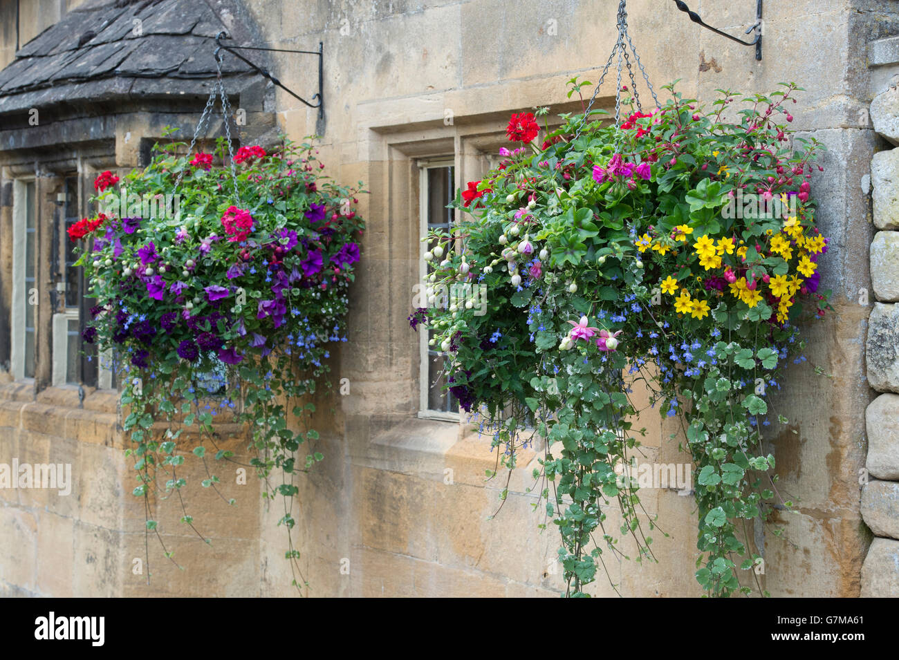 Nei cestini appesi sulla parte anteriore delle otto campane pub. Chipping Campden, Gloucestershire, Inghilterra Foto Stock