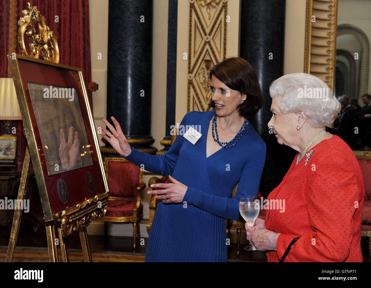 La regina Elisabetta II (a destra), è rappresentata una copia della Magna  carta a Buckingham Palace, nel centro di Londra, dal dottor Claire Breay  della British Library, durante un ricevimento in occasione
