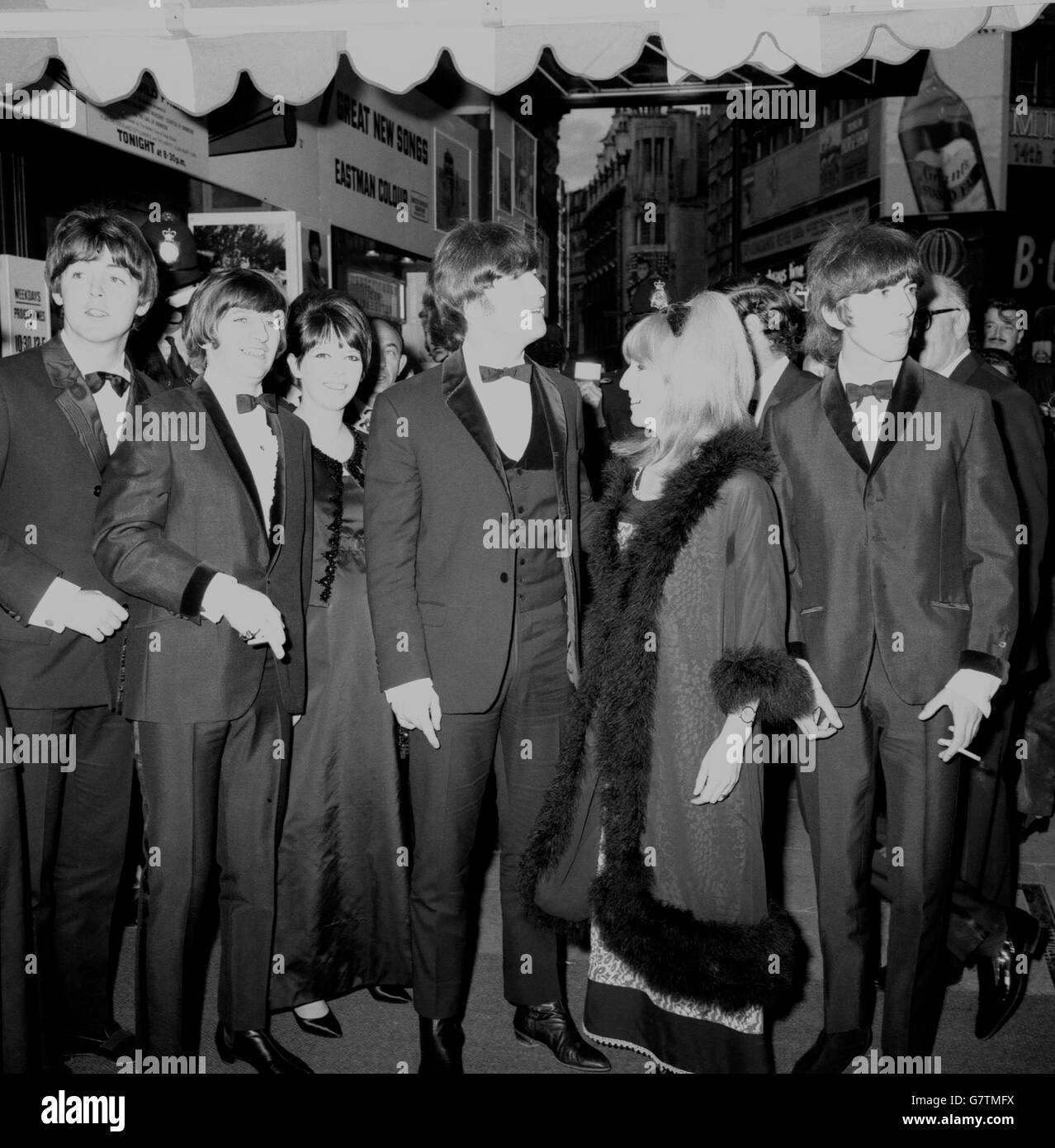 I Beatles, con le loro mogli, arrivano al London Pavilion, Piccadilly Circus, Londra, per la prima mondiale del loro nuovo film "Help!". (L-R) Paul McCartney, Ringo Starr e sua moglie Maureen, John Lennon e sua moglie Cynthia, e George Harrison. Foto Stock