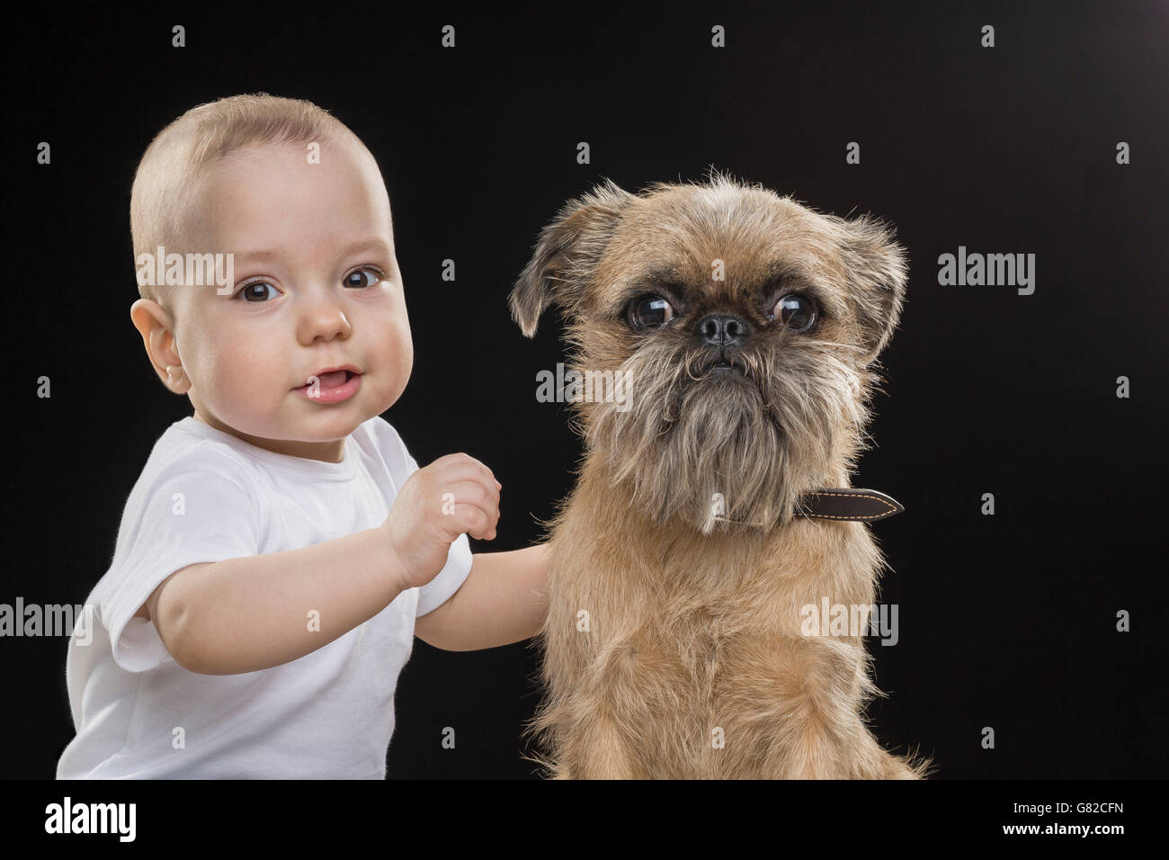Ritratto di ragazzo con cane su sfondo nero Foto Stock