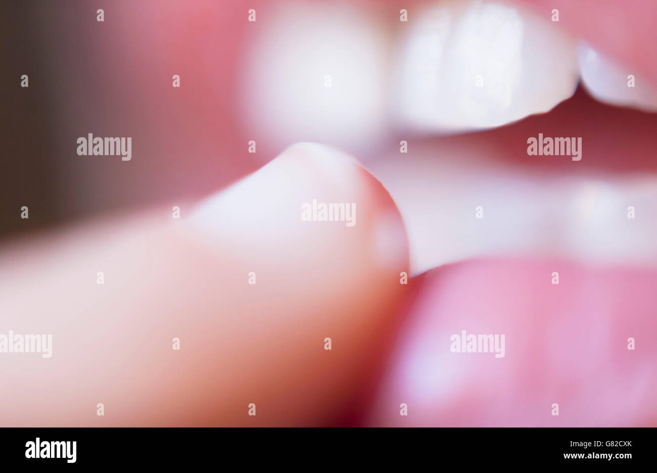 Extreme close-up del dito tocchi le labbra Foto Stock