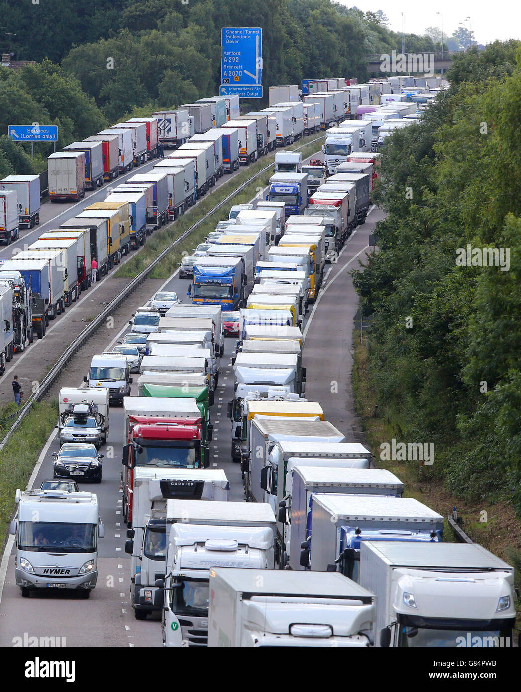 Gli autocarri sono accodati come parte dell'operazione Stack lungo le carreggiate Nord e Sud della M20 ad Ashford, Kent, dopo la morte di un migrante nell'ultima incursione sul tunnel sotto la Manica di Calais. Foto Stock