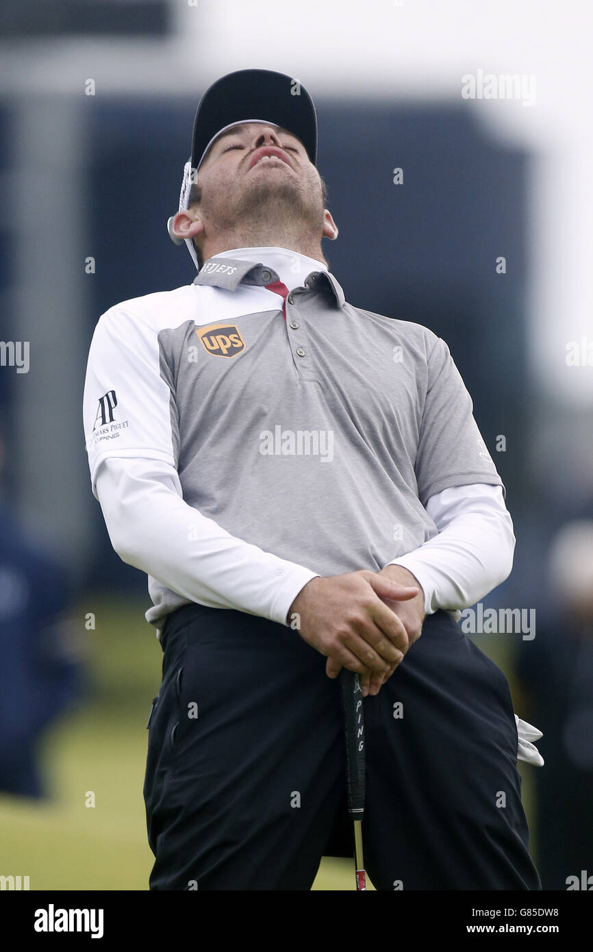 Louis Oosthuizen, sudafricano, reagisce mentre fa impallidire il terzo foro di posa, il 17°, durante il quinto giorno dell'Open Championship 2015 a St Andrews, Fife. Foto Stock