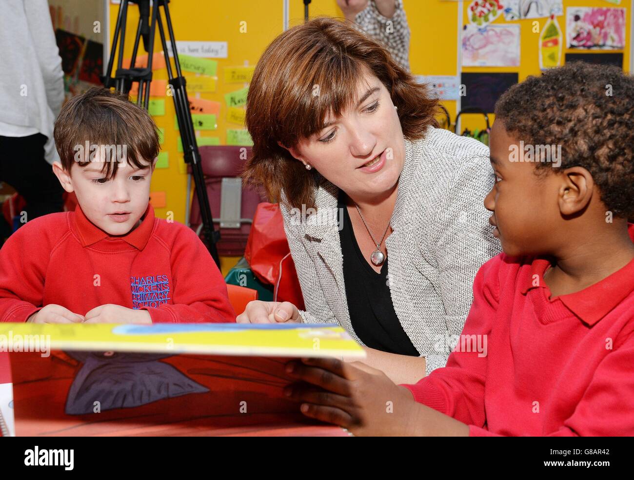 Il Segretario per l’istruzione Nicky Morgan legge da un libro ai bambini piccoli della Charles Dickens Primary School a Londra sud, come parte di un’azione governativa annunciata oggi per farli iniziare a leggere. Foto Stock