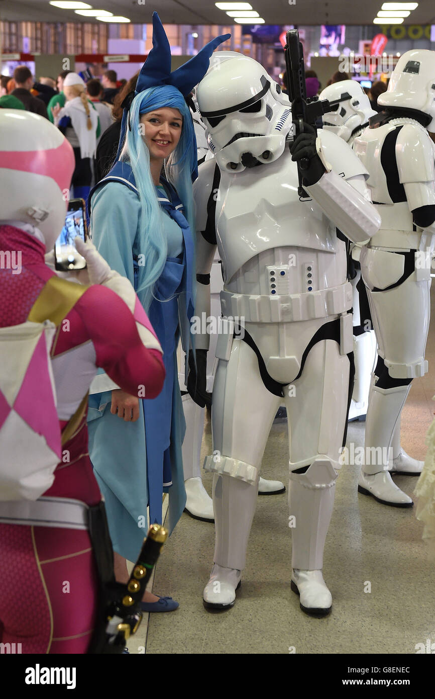 Una ragazza vestita da Kimberly di Power Rangers scatta una foto di un Stormtrooper di Star Wars durante il MCM Comic con al NEC di Birmingham. Foto Stock