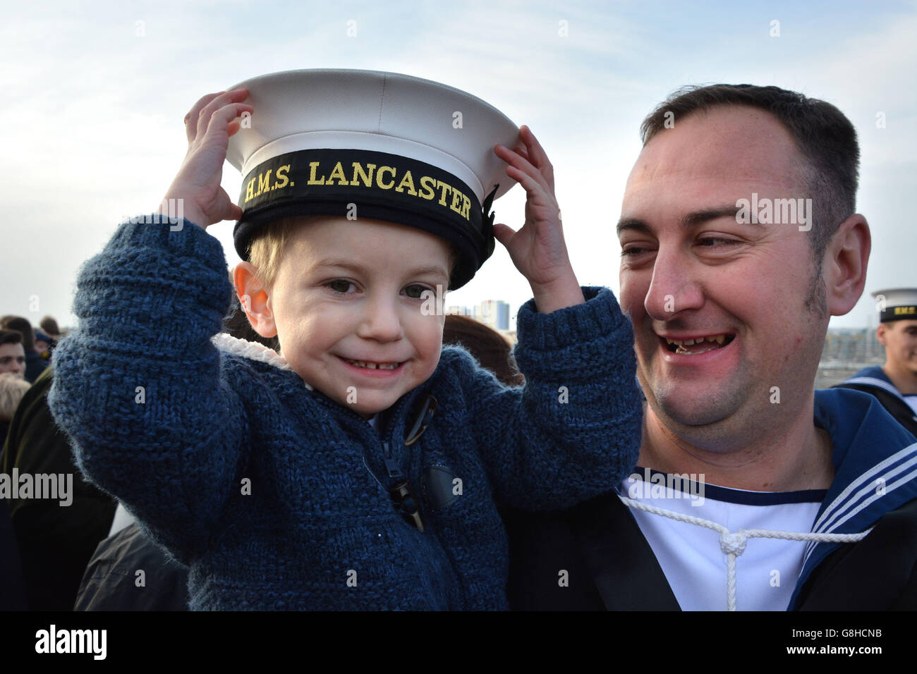 Leading Seaman Matt 'Spend-a' Penny da Lee-on-the-Solent, Hampshire, è accolto a casa da suo figlio, Alfie, tre anni, mentre torna a bordo dell'HMS Lancaster alla base navale di Portsmouth dopo che la Royal Navy Frigate ha completato un viaggio di 35,000 miglia attraverso quattro oceani. Foto Stock