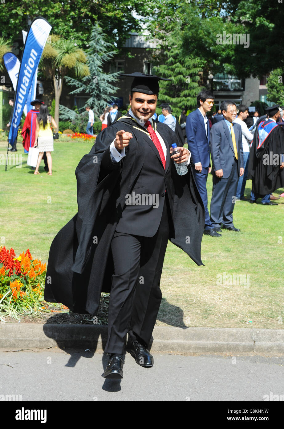 Un maschio studente laureato in abito completo con hat esprimere enorme gioia sul giorno di graduazione presso la Queen Mary University di Londra. Foto Stock