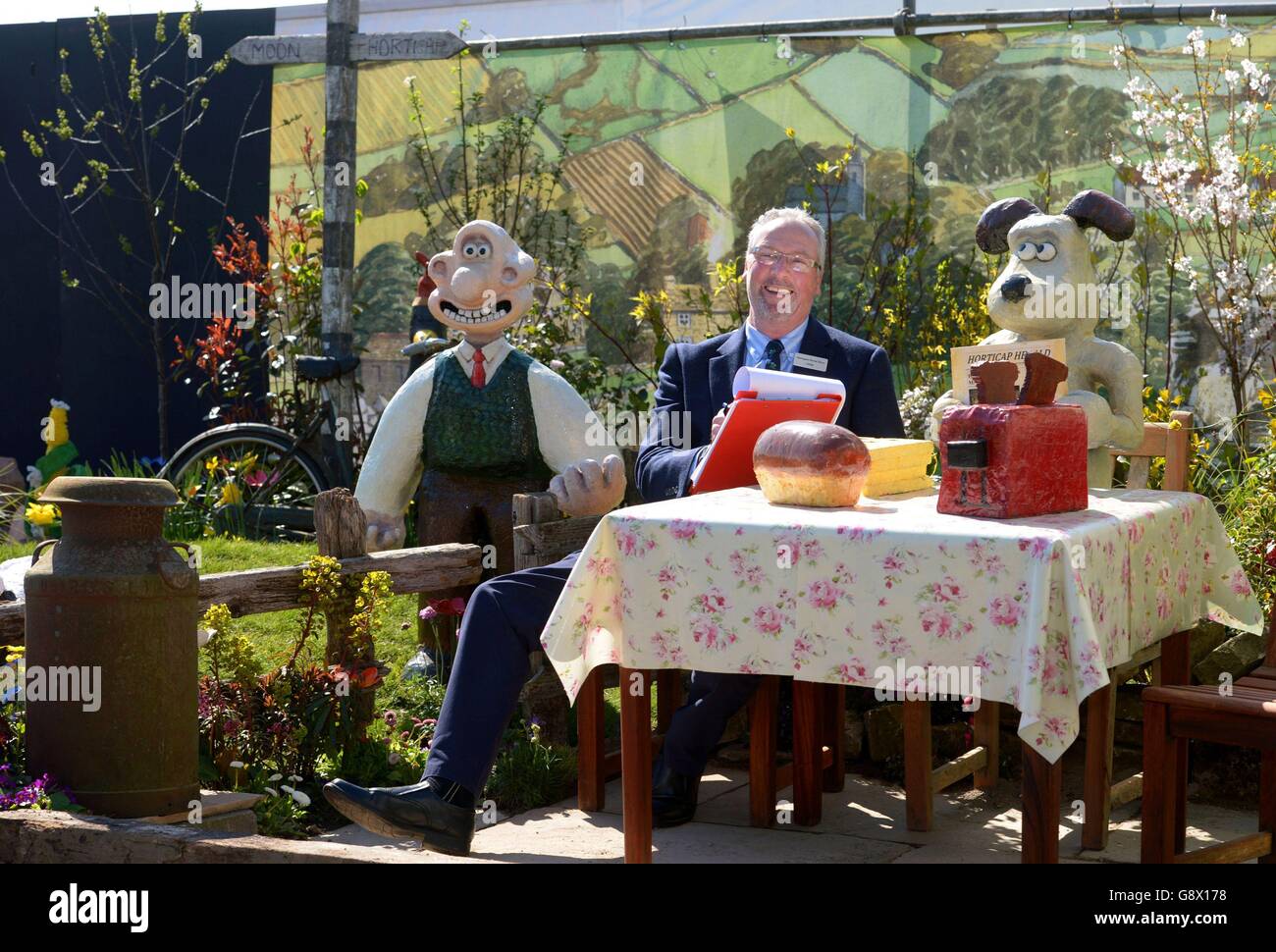 Il giudice Nigel Harrison si trova all'interno di un giardino a tema Wallace and Grommit chiamato "UN grande giorno fuori" durante la giornata di allestimento all'Harrogate Spring Flower Show, North Yorkshire. Foto Stock