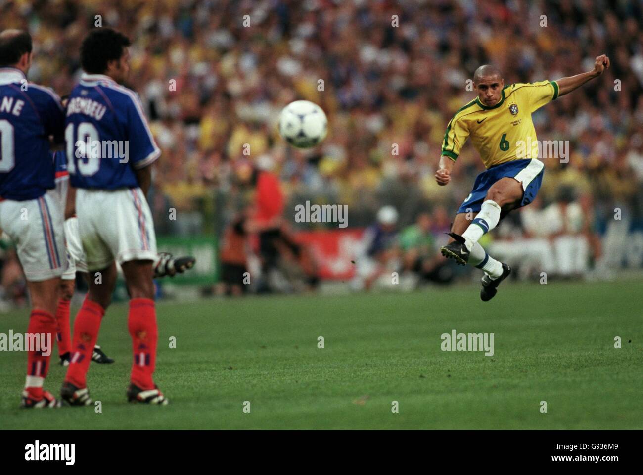 Calcio - Coppa del mondo Francia 98 - finale - Brasile / Francia. Roberto Carlos del Brasile (a destra) cerca di arricciare un calcio libero intorno al muro della Francia Foto Stock