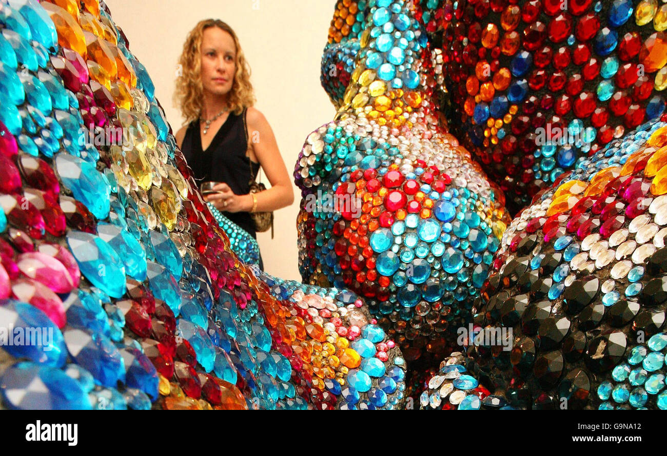Una donna guarda la scultura dell'artista Tony Heywood chiamata 'Shimmer' alla fine Art Society di Londra, realizzata con 150'000 gioielli e basata sulla forma di microrganismi. Foto Stock