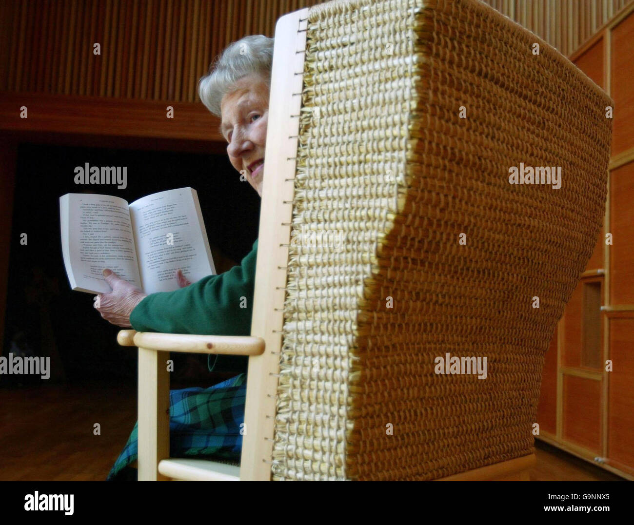 Lo storyteller Audrey Parks si trova su una sedia fatta dall'artigiano Orkney Robert Towers come tributo a George Mackay Brown e alle sue storie al centro storico scozzese di Edimburgo. Foto Stock