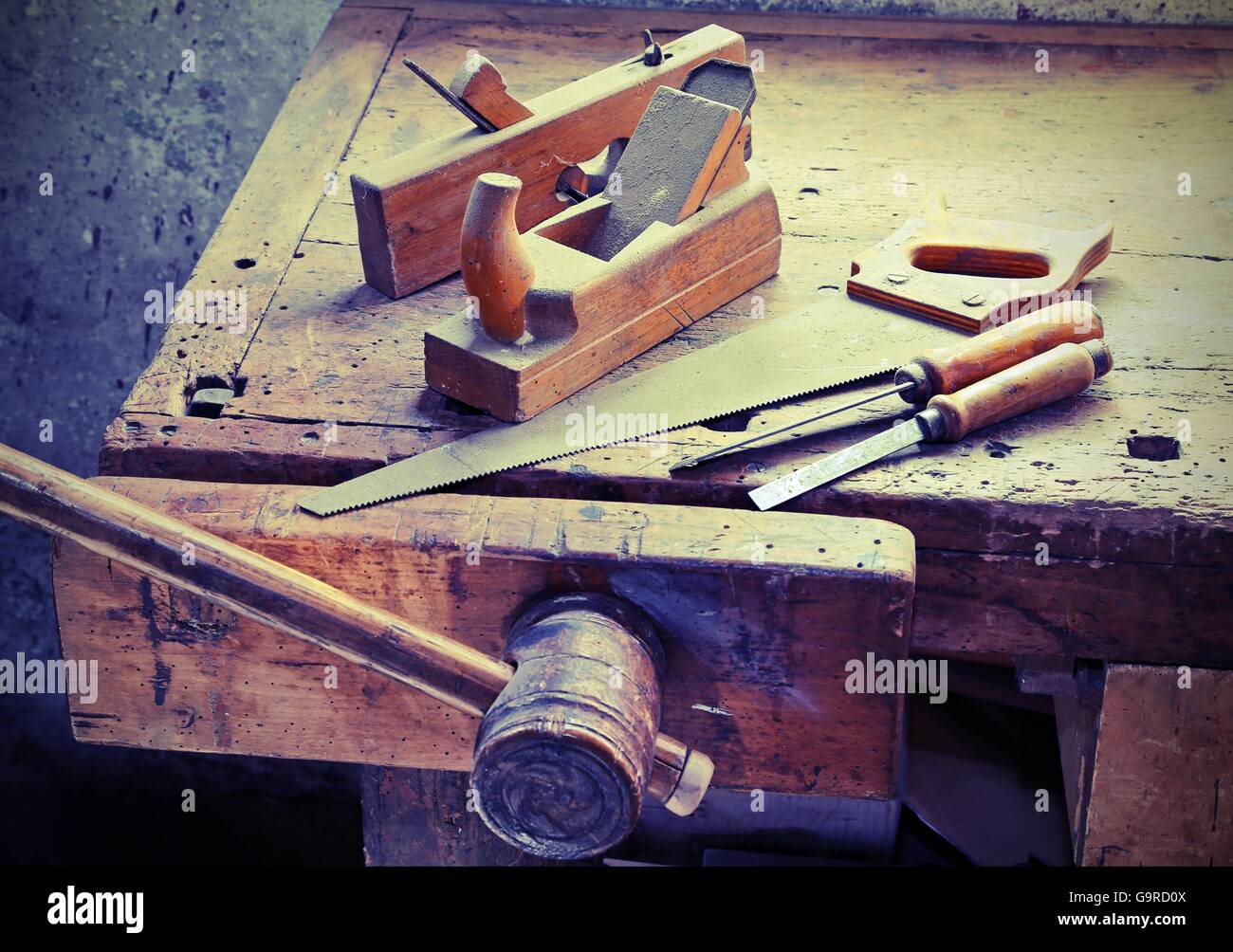 Piani e scalpelli e una sega sul banco di lavoro con una morsa in legno Foto Stock