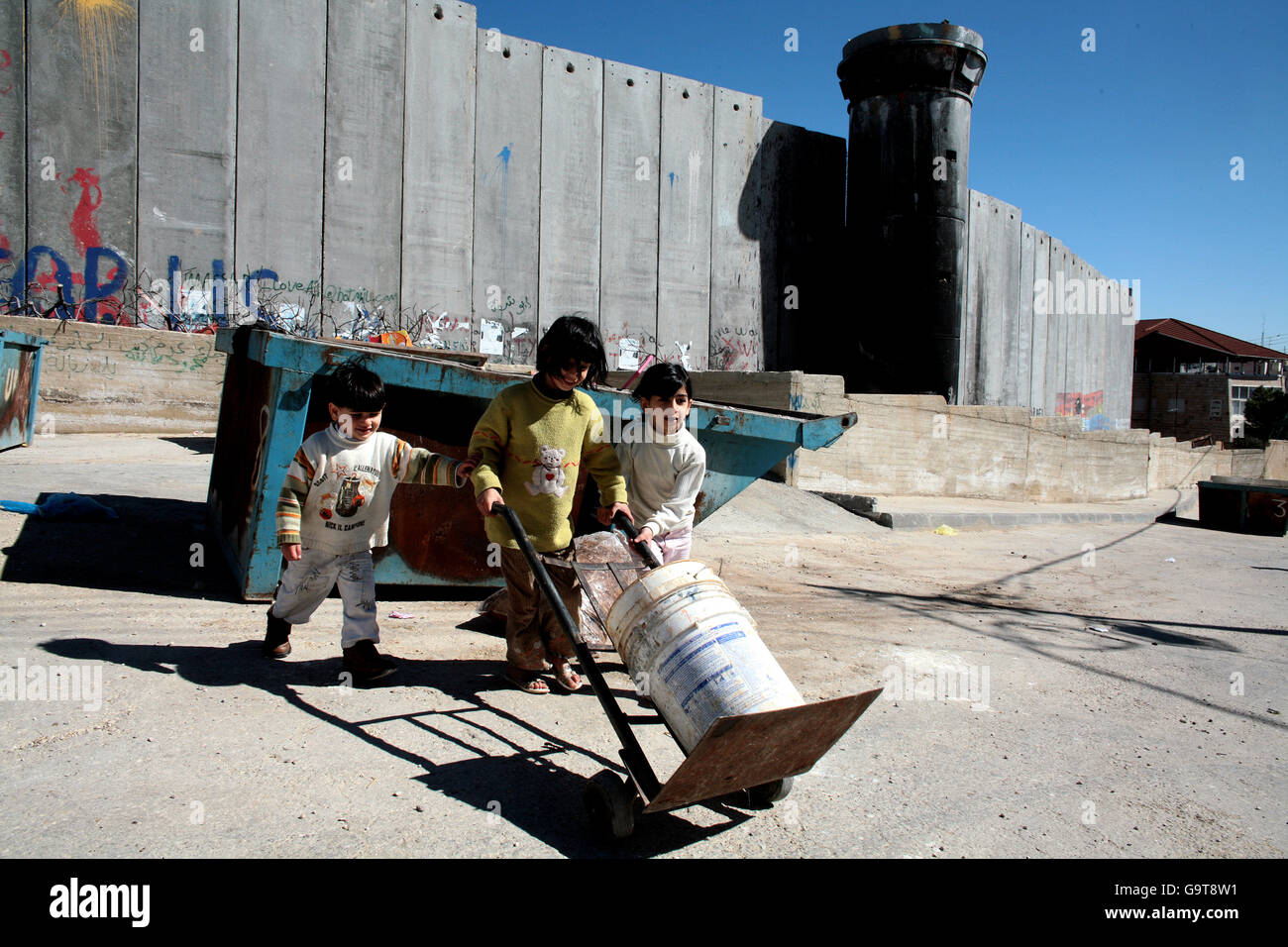 Bambini vicino alla barriera della Cisgiordania israeliana a Gerusalemme. Foto Stock