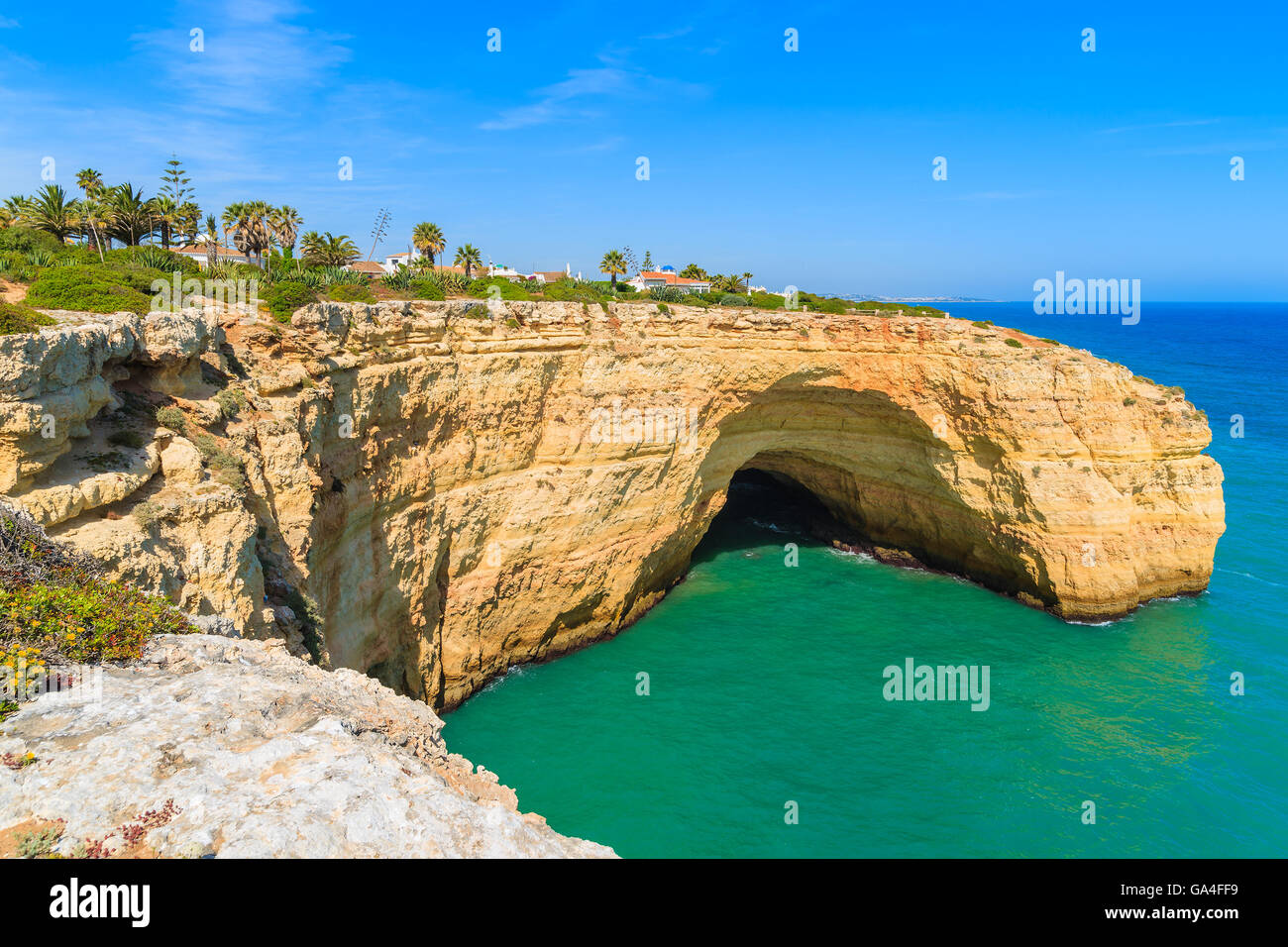 Grotta di roccia e oceano turchese sulla costa del Portogallo vicino a Carvoeiro città, regione Algarve Foto Stock