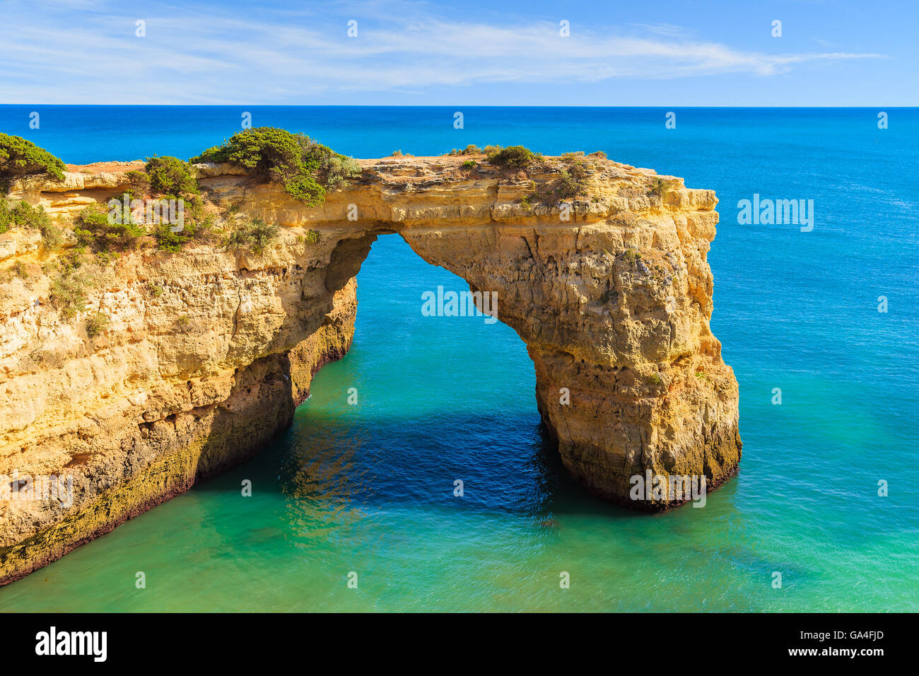 Roccia arch vicino a Marinha spiaggia e mare blu sulla costa del Portogallo nella regione di Algarve Foto Stock