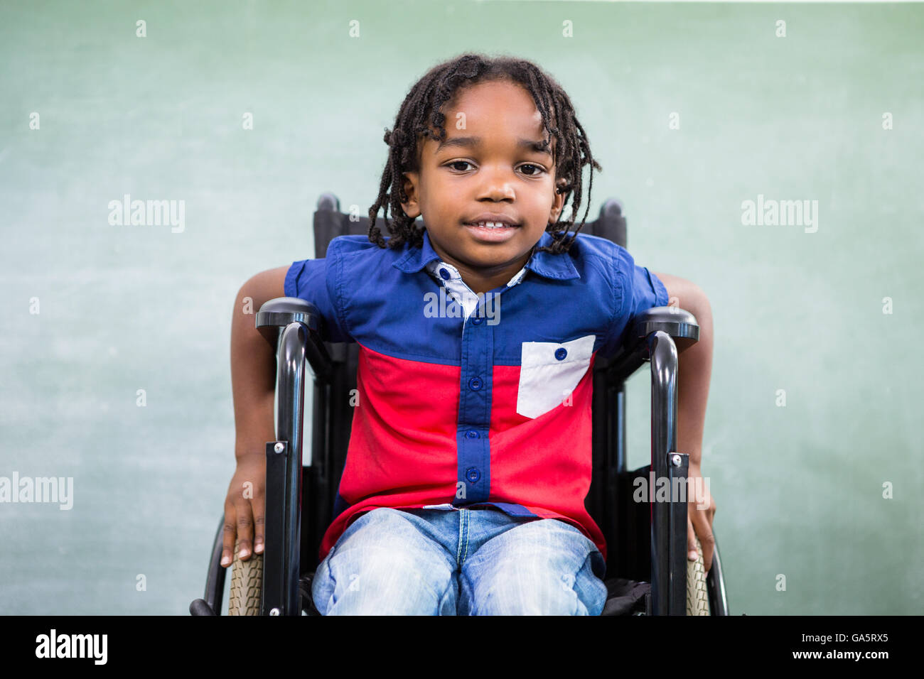 Ritratto di ragazzo di portatori di handicap in aula Foto Stock