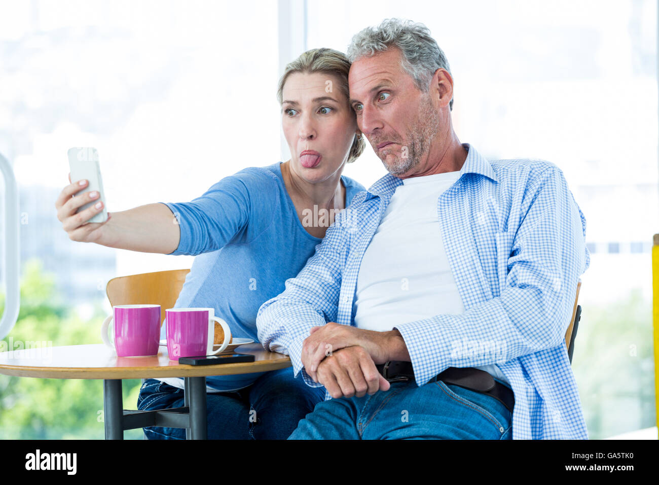 Coppia matura tenendo selfie a casa Foto Stock