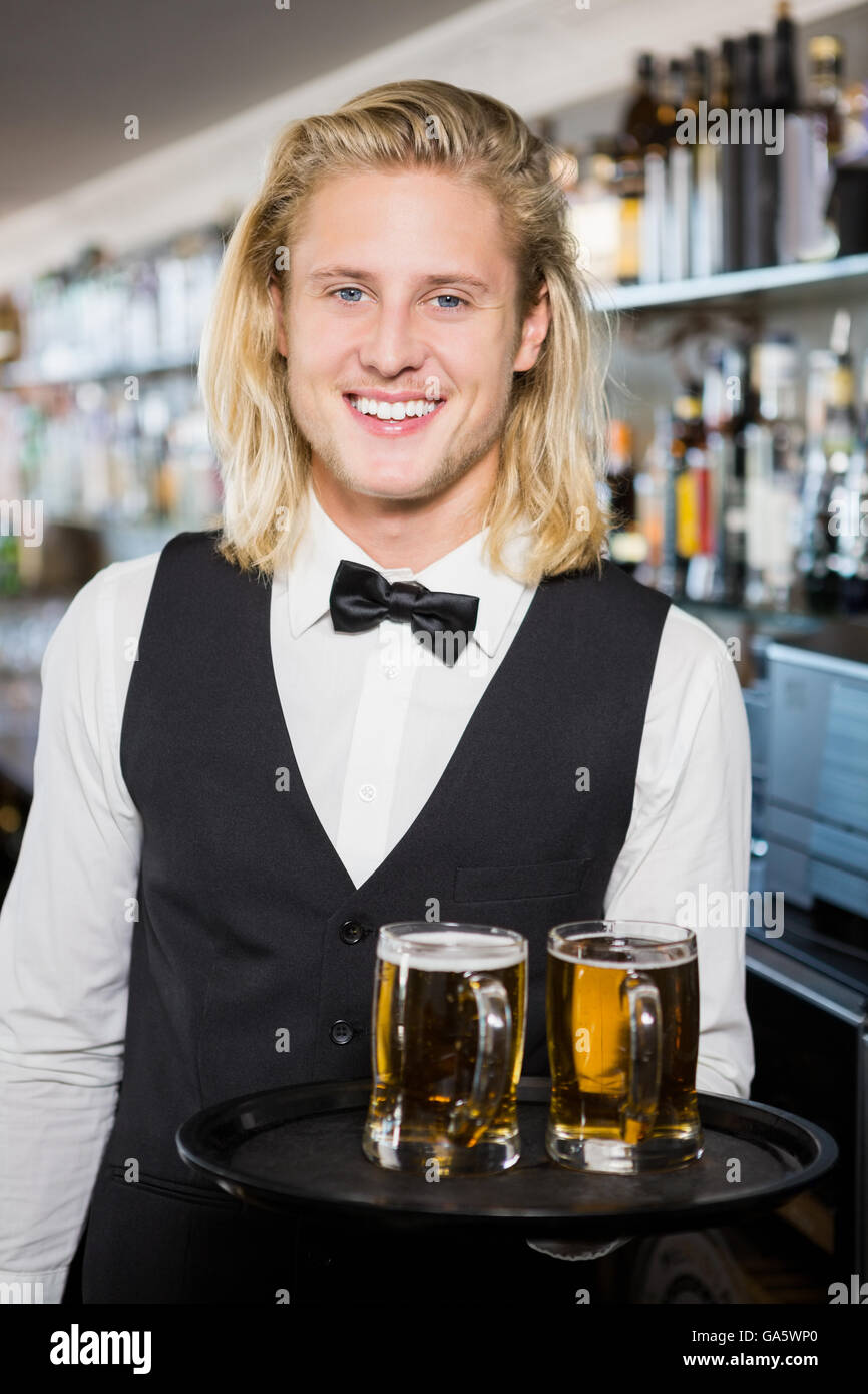 Ritratto di cameriere tenendo il vassoio con il boccale di birra Foto Stock