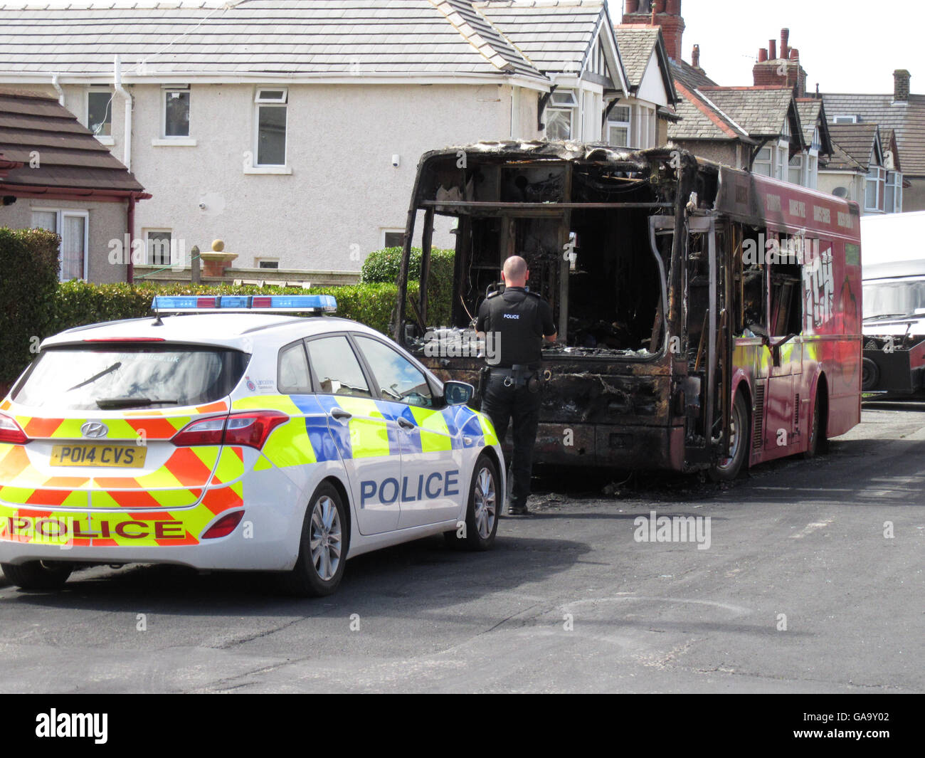 Halden Road Heysham, Morecambe Lancashire Regno Unito, 4 agosto 2016 un funzionario di polizia presso la scena delle ultime notti autobus incendio che ha distrutto un autobus parcheggiato in una zona residenziale di Heysham. Forze di polizia sono il trattamento di l'incendio che ha distrutto un autobus parcheggiato in Halden Road, Heysham come credito di arson: David Billinge/Alamy Live News Foto Stock