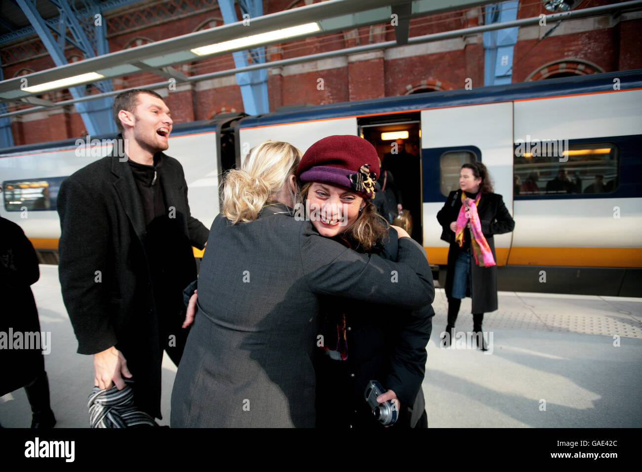 Gli amici si salutano mentre arrivano da Brussells sul primo treno ad alta velocità per arrivare al nuovo terminal alla stazione di St Pancras. Foto Stock