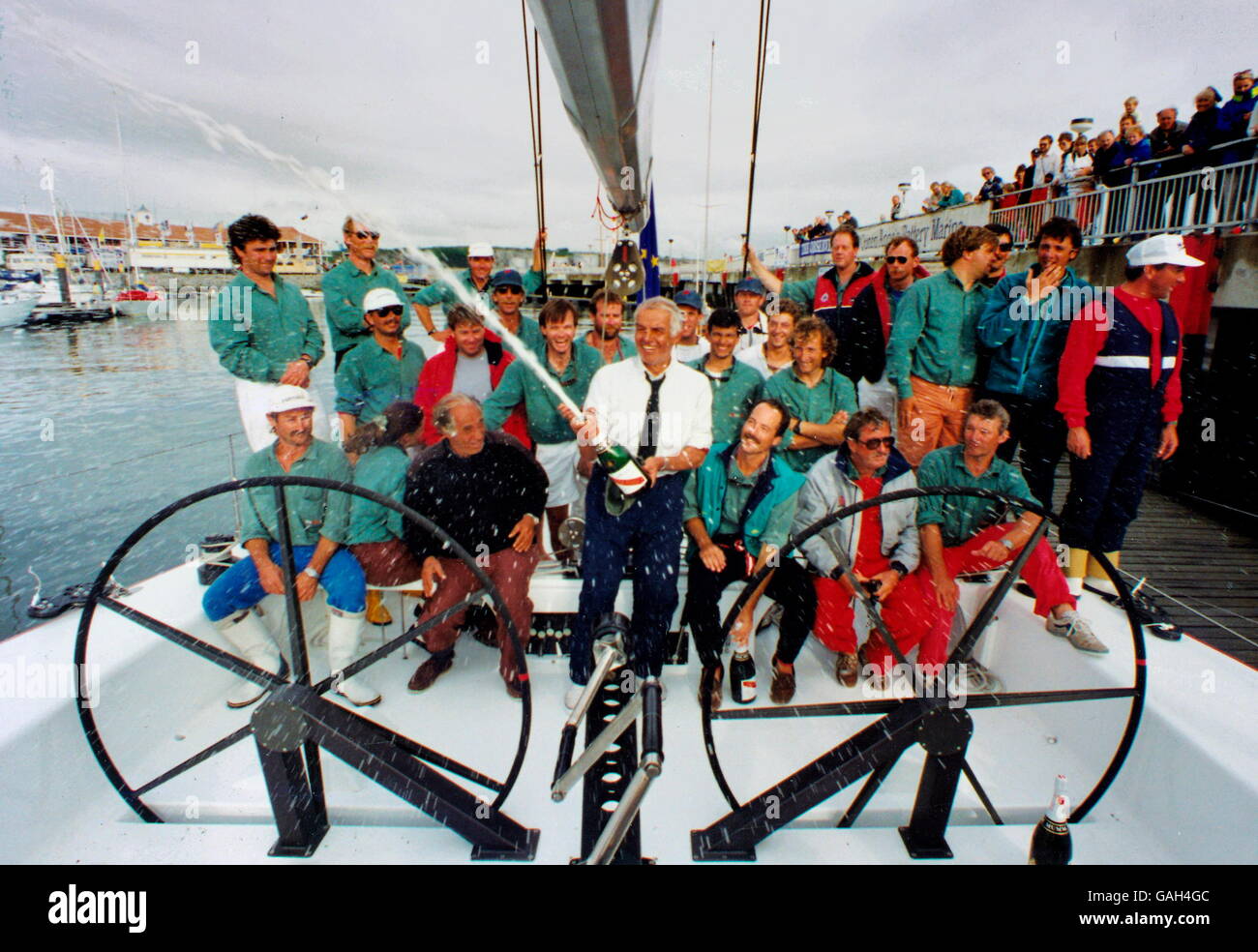 AJAX NEWS FOTO. 1991. PLYMOUTH in Inghilterra. - Vincitore celebra - Italiana Raoul GARDINI CELEBRA IL SUO YACHT FASTNET vittoria in gara con una bottiglia di champagne a Plymouth procedure Dockside Wizard. Foto:JONATHAN EASTLAND/AJAX. REF:91CP/GARDINI. Foto Stock