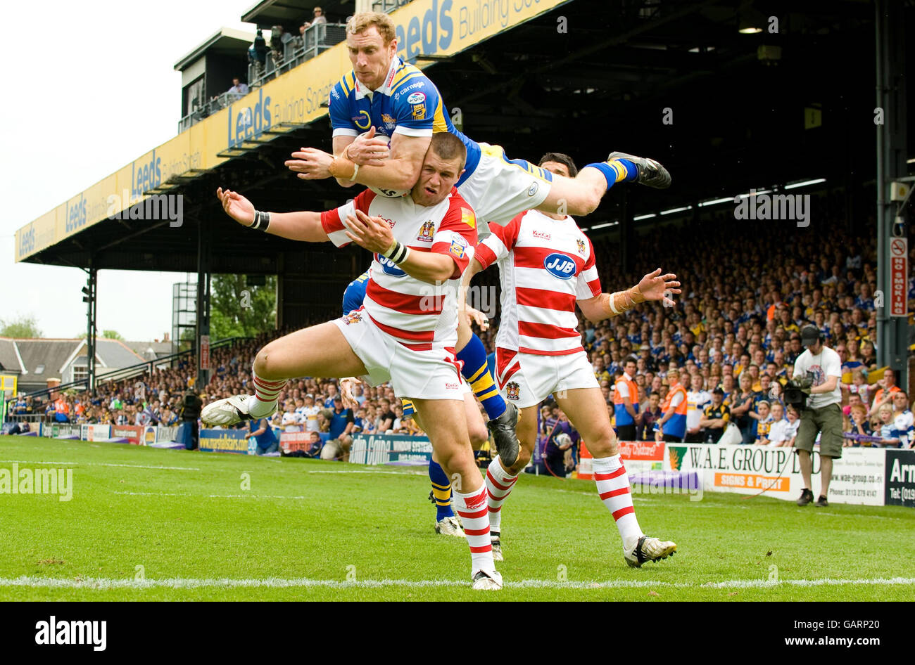 Scott Donald di Leeds supera Darrell Goulding di Wigan per raccogliere un pallone alto durante la partita finale del quartiere della Coppa sfida all'Headingley Carnegie Stadium di Leeds. Foto Stock