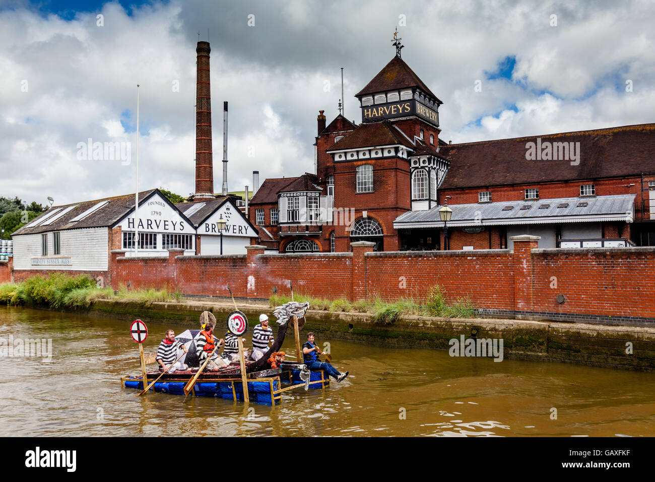 Un Falò della società passa zattera birrificio Harveys mentre competere in un la zattera annuale gara sul fiume Ouse, Lewes, Sussex, Regno Unito Foto Stock