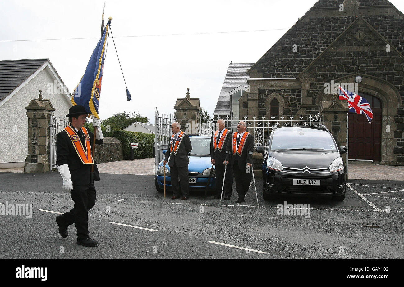 Gli uomini arancioni di Portadown marciano passando la chiesa di Drumcree mentre al Lodge è impedito di marciare lungo la strada nazionalista Garvaghy. Foto Stock