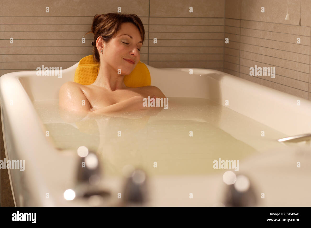 Donna, 35, rilassante in una vasca da bagno, bagno di Afrodite con il siero  di latte, la talassoterapia in una spa resort Foto stock - Alamy