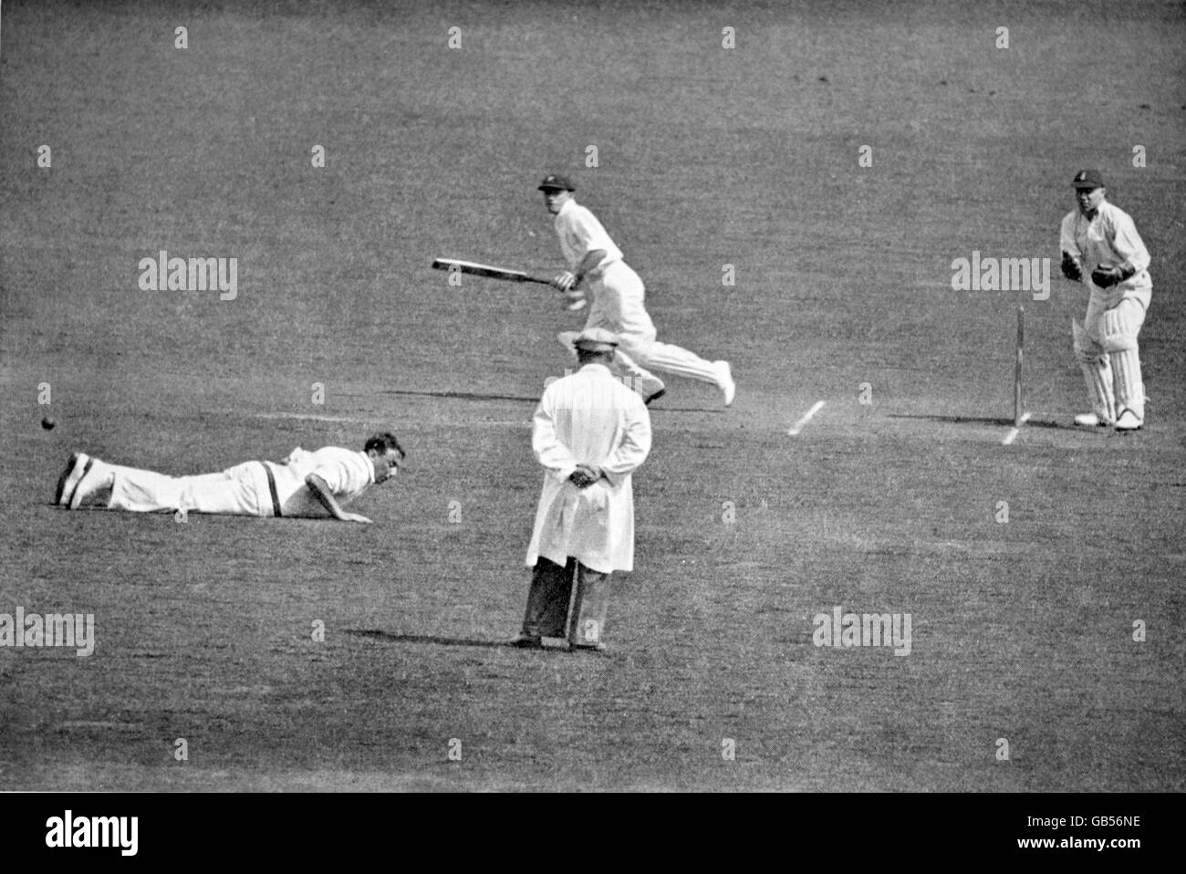 Il Don Bradman (c) dell'Australia aggancia la palla a Maurice Tate (l) dell'Inghilterra, guardato dal wicketkeeper George Duckworth (r) Foto Stock