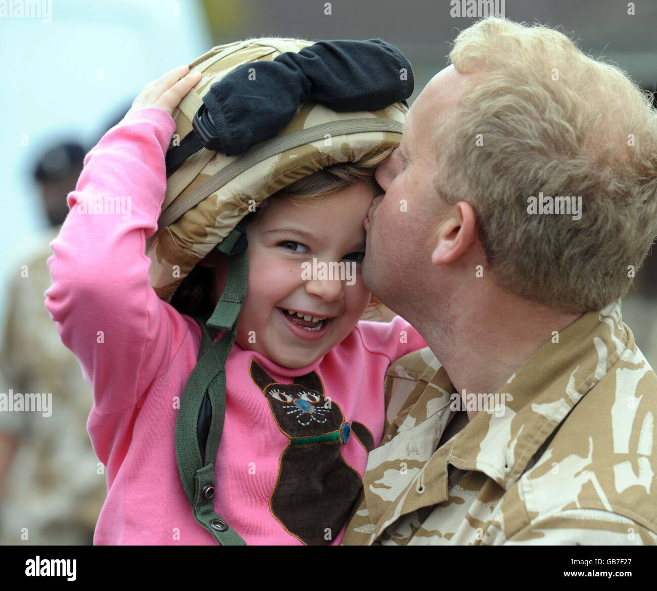 Harriet Moore, 5, ottiene un bacio dal suo papà, maggiore Matt Moore, da vicino Chichester al suo arrivo con 42 batteria, 32 Regiment Royal Artillery a Robert Barracks, Larkhill, Wiltshire. Foto Stock