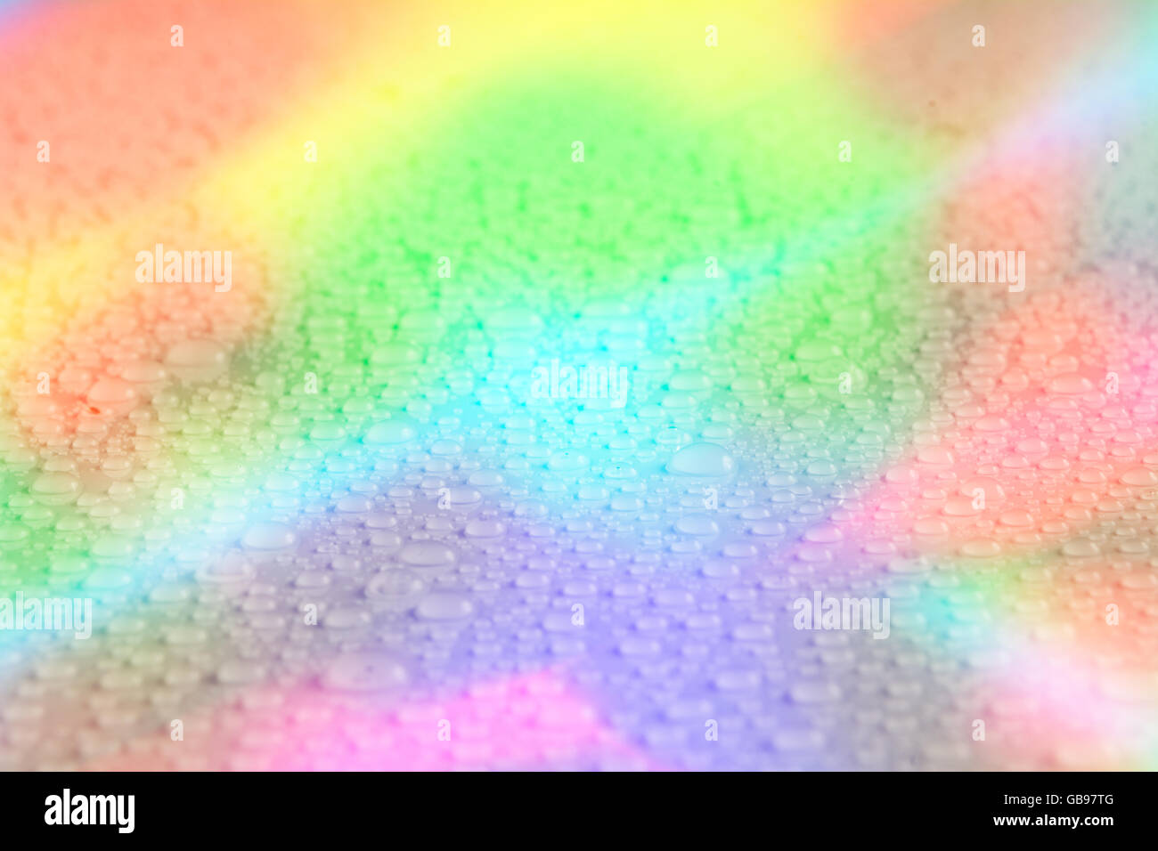 Rainbow goccia d'acqua texture. Goccia di acqua dello sfondo. Sfondo arcobaleno Foto Stock