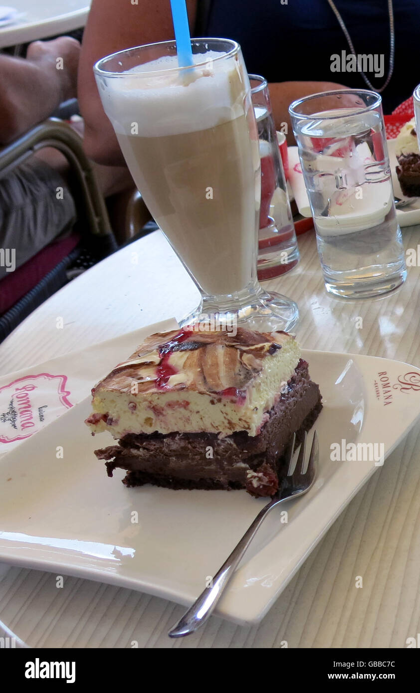Il caffelatte e una fetta di torta Foto Stock