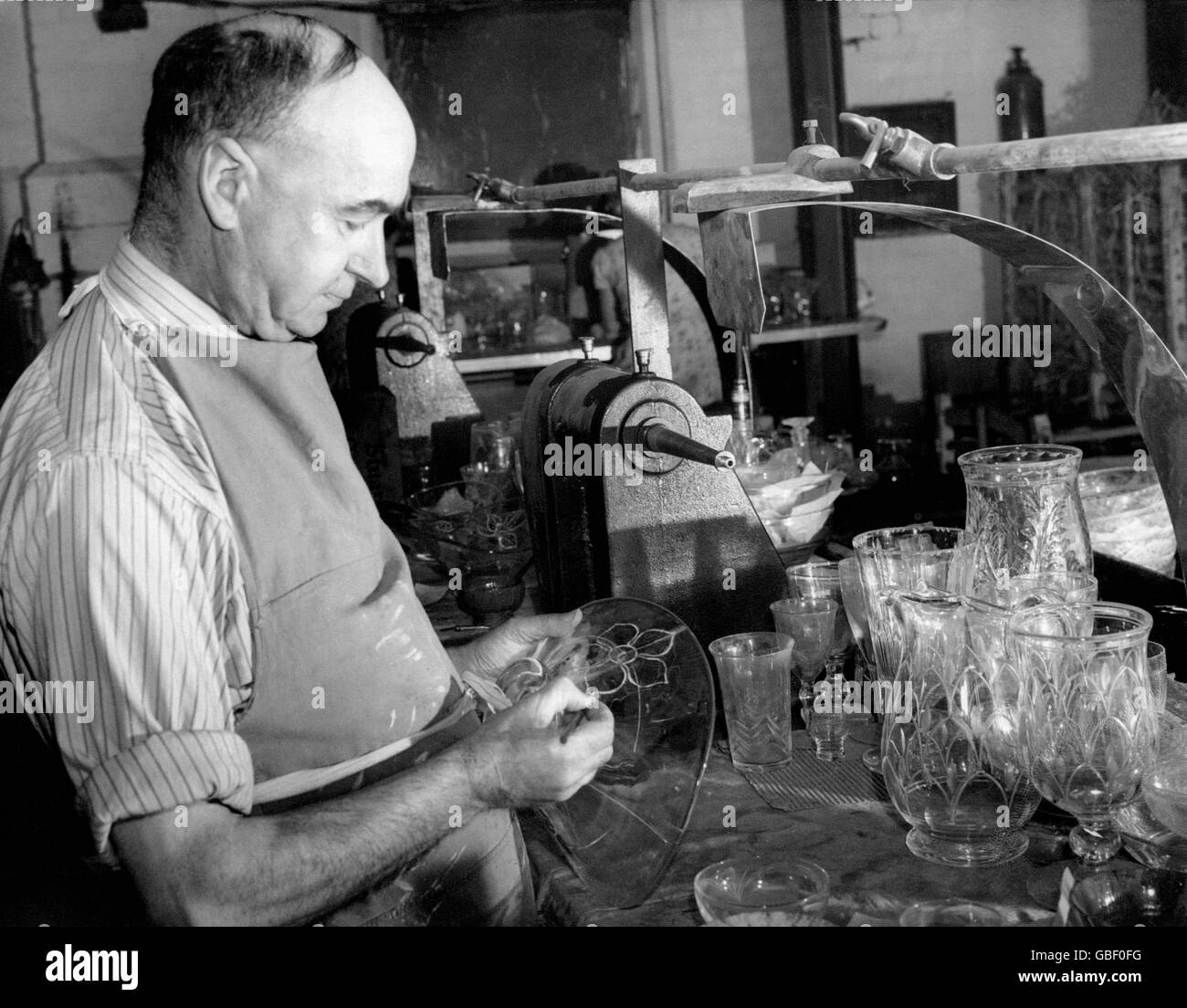 Il vetraio Percy Cartwright, qui raffigurato eseguendo uno dei suoi molti intricati disegni su un pezzo di vetro al Stuart Crystal Works di Wordsley in Staffordshire. Foto Stock
