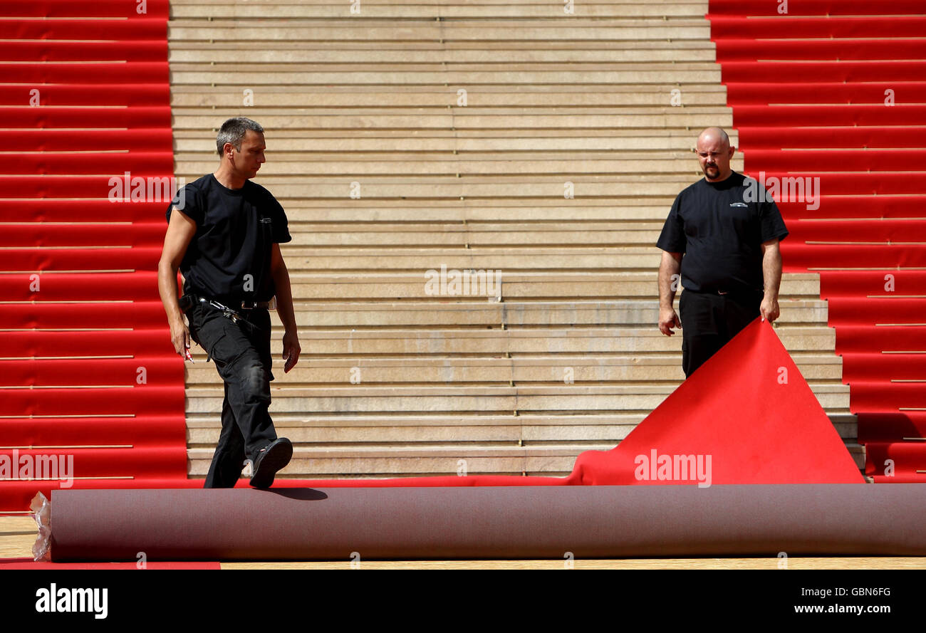 I lavoratori preparano il tappeto rosso sui gradini del Palais des Festivals, a Cannes, in Francia, prima dell'inizio del Festival de Cannes. Foto Stock